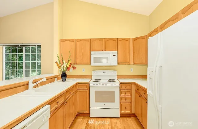 a kitchen with a stove a sink and a microwave