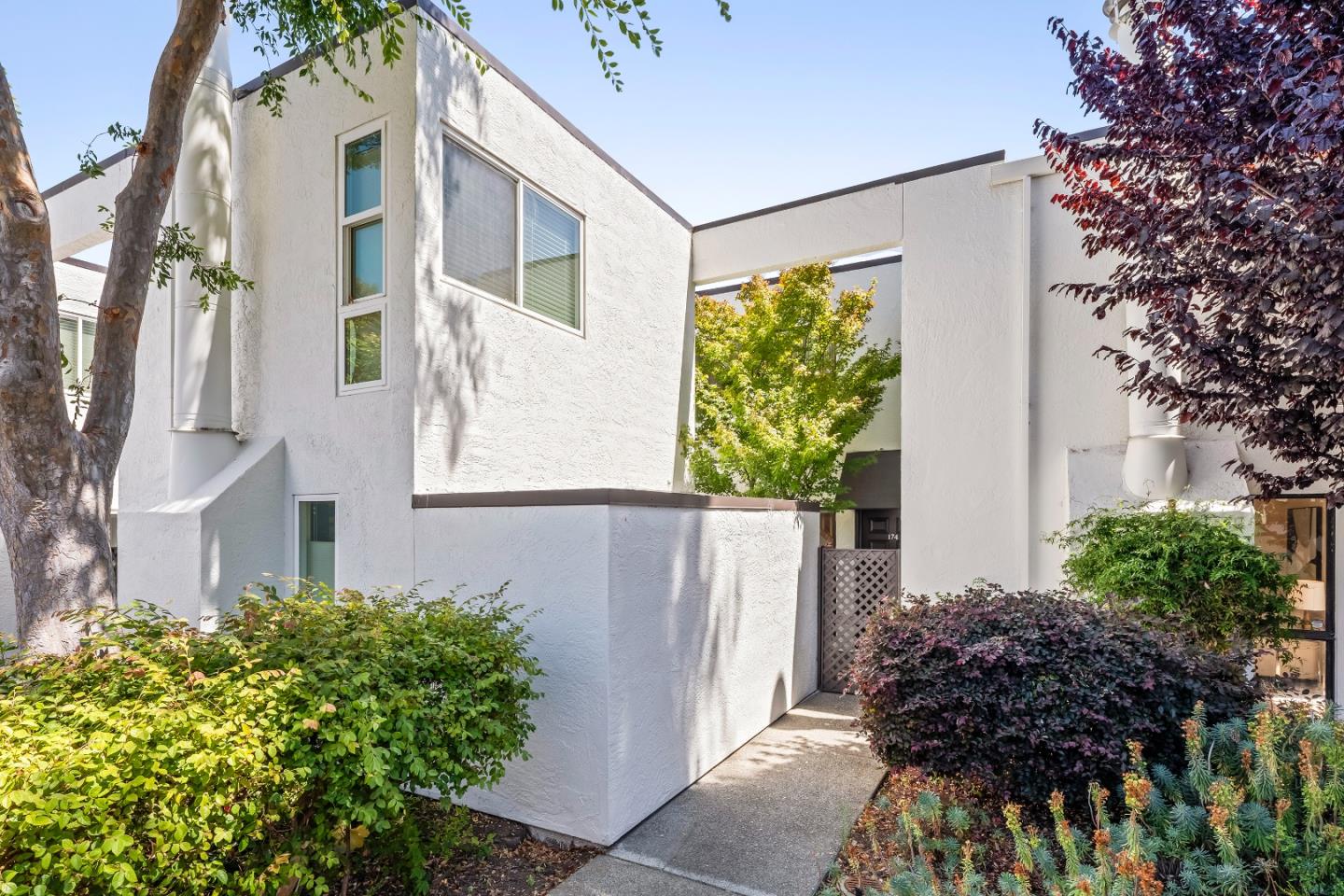 a view of a house with a small yard and plants
