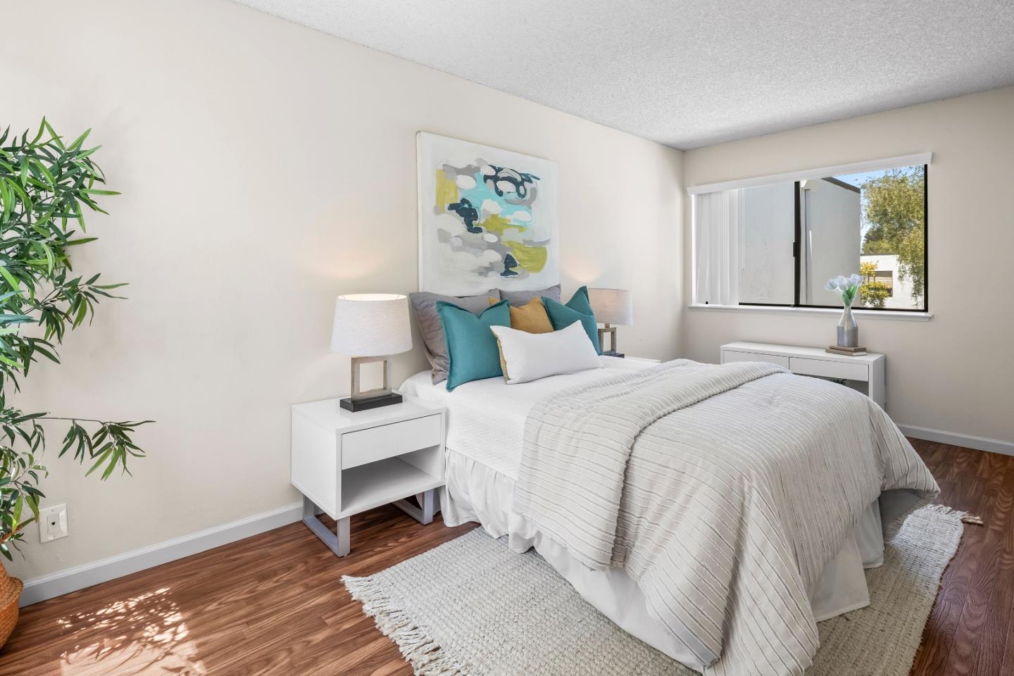 2001 Alameda De Las Pulgas, Unit 174 San Mateo, CA 94403 - Photo 11 of 16 a bedroom with a bed lamp and a potted plant