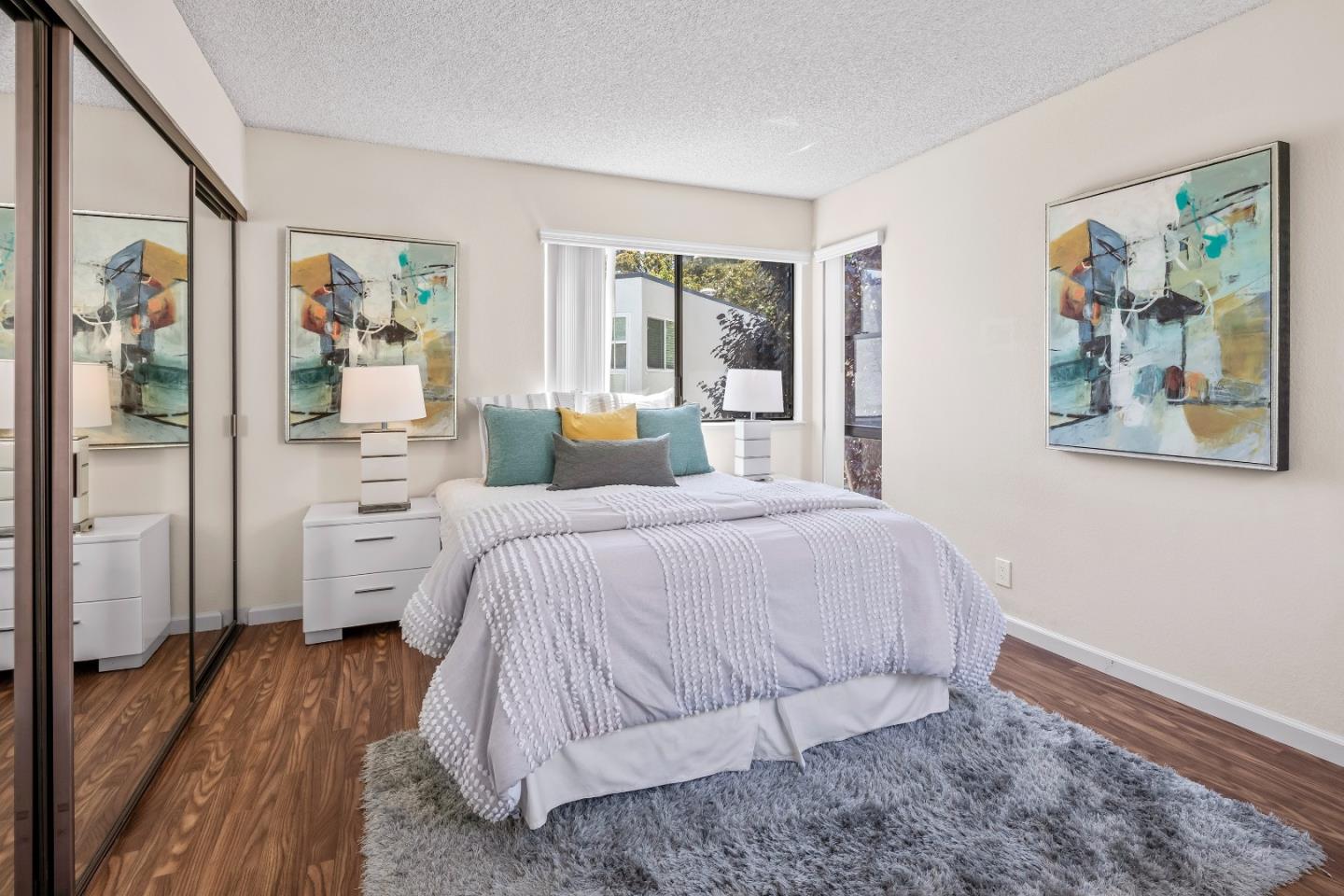 2001 Alameda De Las Pulgas, Unit 174 San Mateo, CA 94403 - Photo 12 of 16 a bedroom with a bed and a painting on the wall