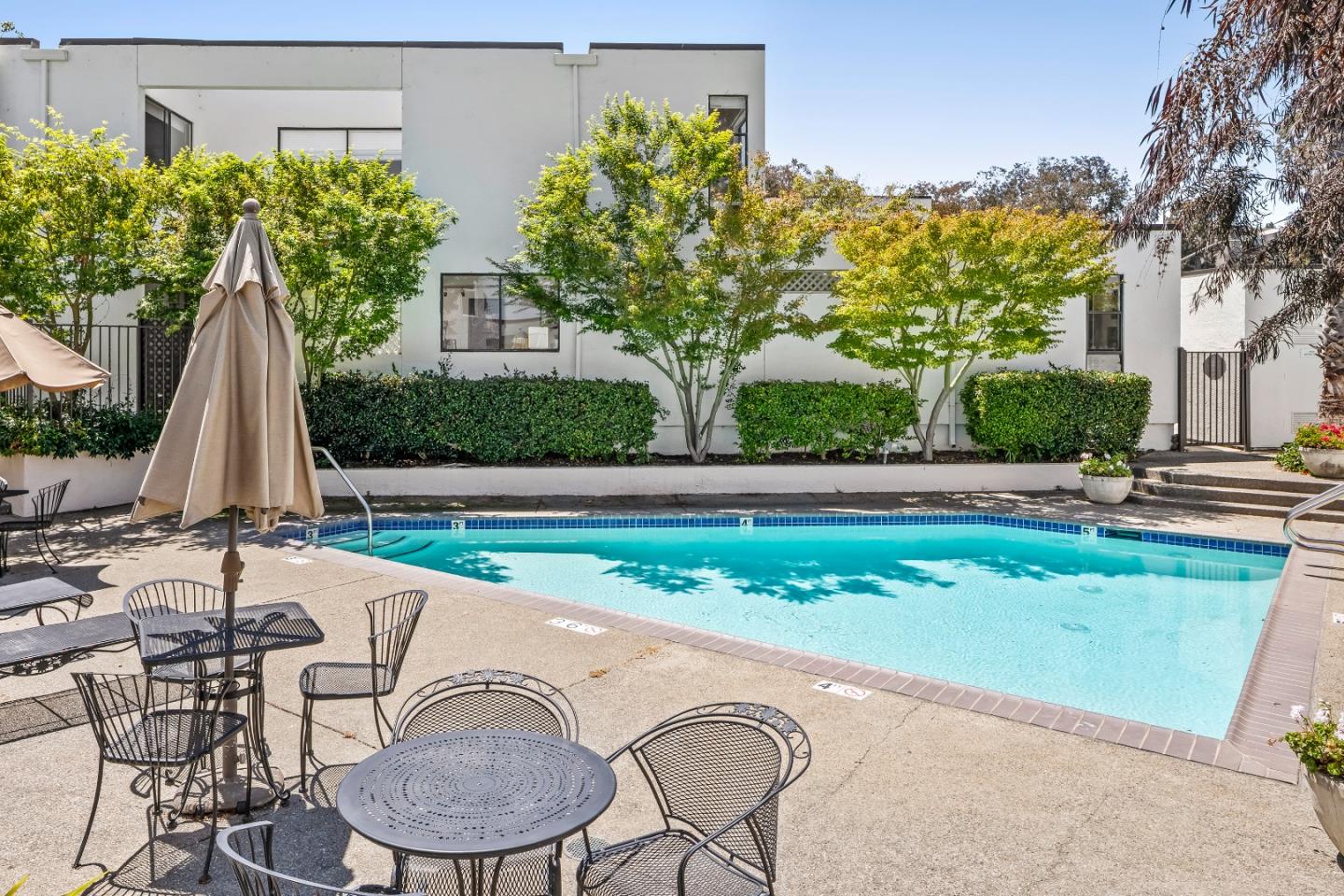 2001 Alameda De Las Pulgas, Unit 174 San Mateo, CA 94403 - Photo 16 of 16 a view of backyard with swimming pool and chair