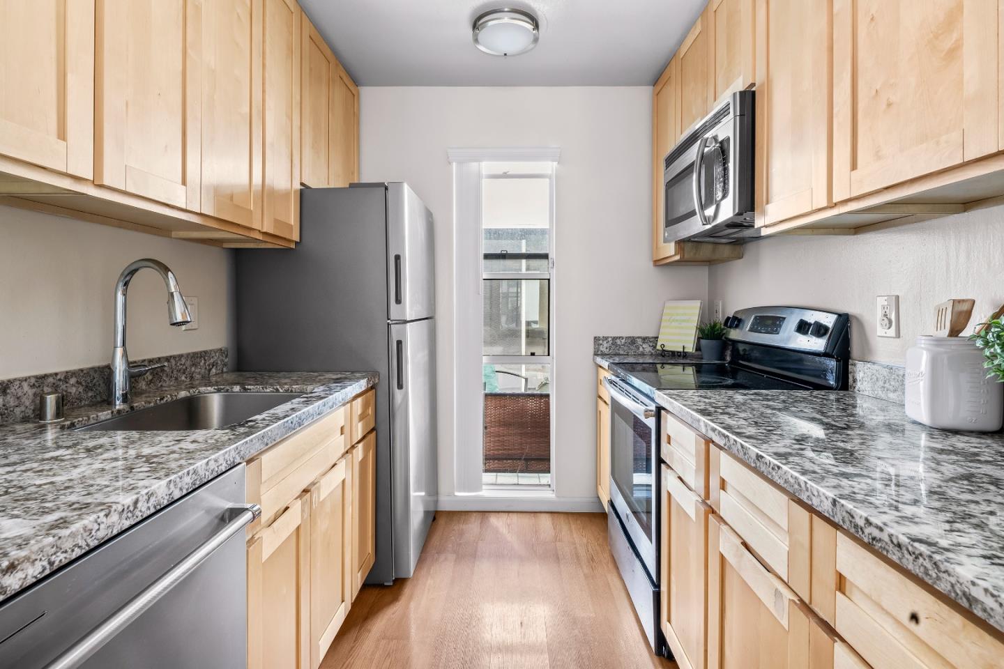 2001 Alameda De Las Pulgas, Unit 174 San Mateo, CA 94403 - Photo 5 of 16 a kitchen with stainless steel appliances granite countertop a sink stove and refrigerator