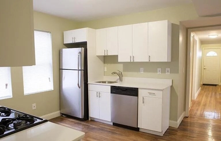 4043 Washington Street, Unit 2 Boston, MA 02131 - Photo 2 of 8 a kitchen with a refrigerator sink and cabinets