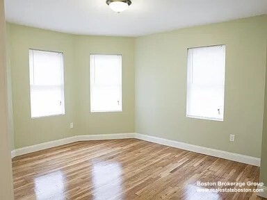 4043 Washington Street, Unit 2 Boston, MA 02131 - Photo 5 of 8 a view of a room with wooden floor and windows
