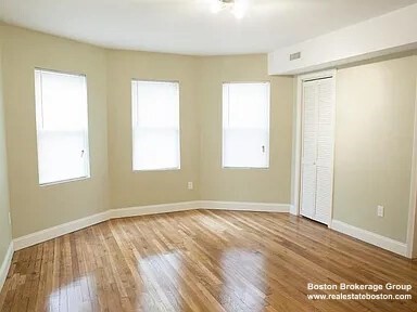 4043 Washington Street, Unit 2 Boston, MA 02131 - Photo 7 of 8 a view of an empty room with wooden floor and a window