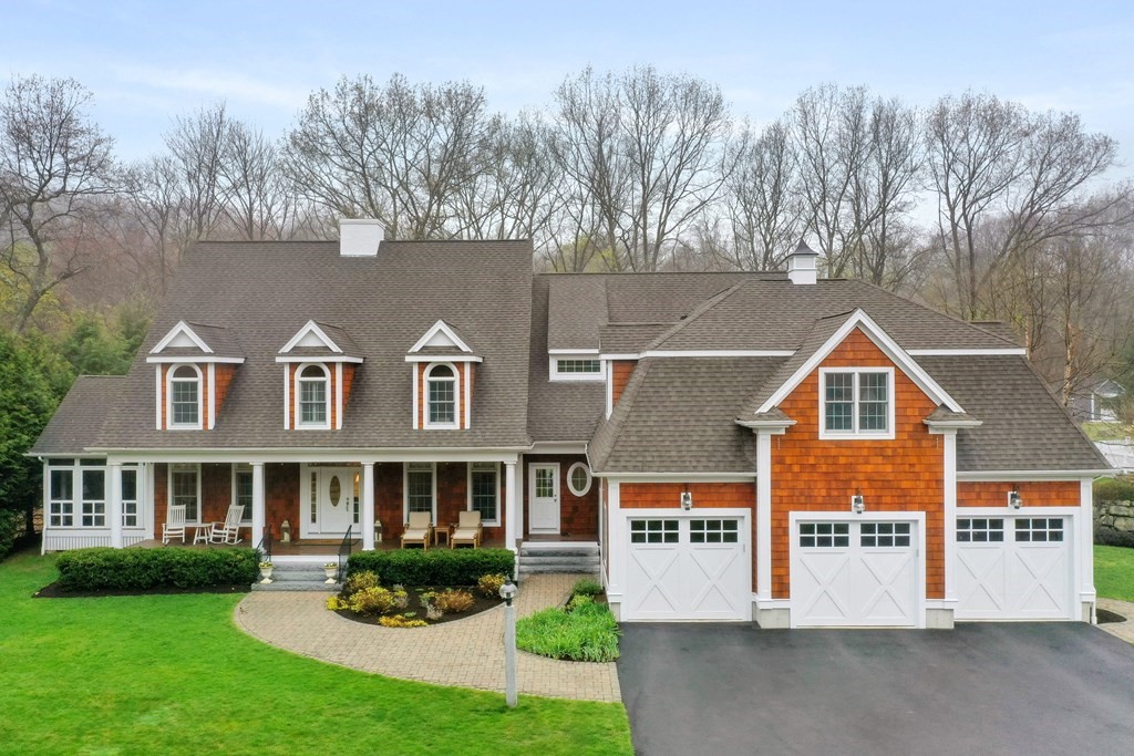 a front view of a house with a garden and plants