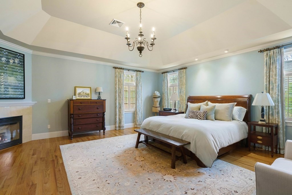 81 Pine Street Dover, MA 02030 - Photo 20 of 40 a spacious bedroom with a bed and dresser with mirror