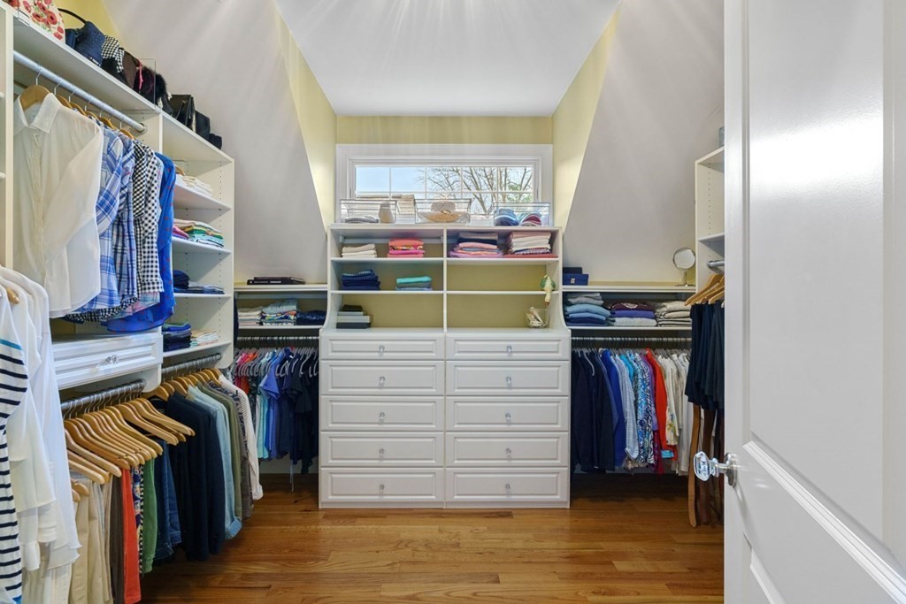 81 Pine Street Dover, MA 02030 - Photo 21 of 40 a view of walk in closet with clothes and shoes