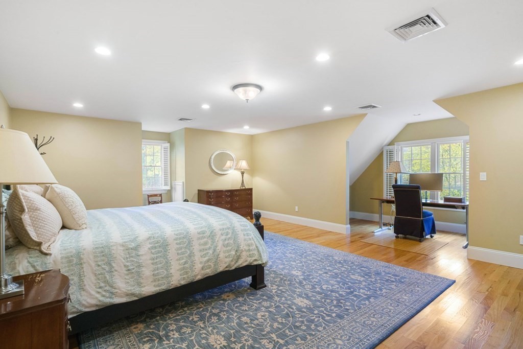 81 Pine Street Dover, MA 02030 - Photo 24 of 40 a bedroom with a bed and wooden floor