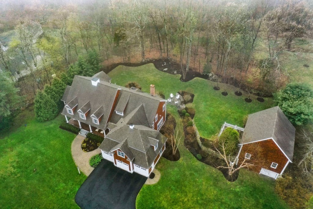 81 Pine Street Dover, MA 02030 - Photo 3 of 40 an aerial view of a backyard with chairs and a garden