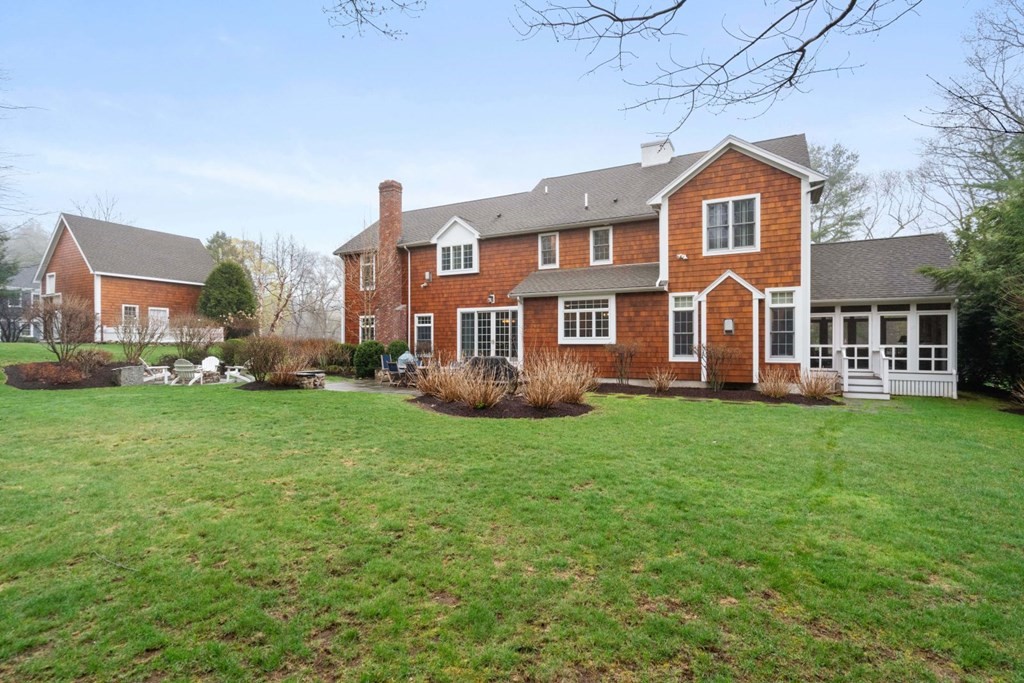 81 Pine Street Dover, MA 02030 - Photo 35 of 40 a front view of a house with a yard