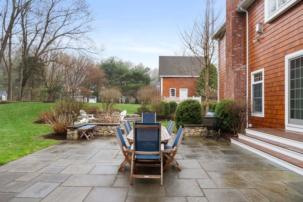 81 Pine Street Dover, MA 02030 - Photo 36 of 40 a view of a backyard with sitting area and garden