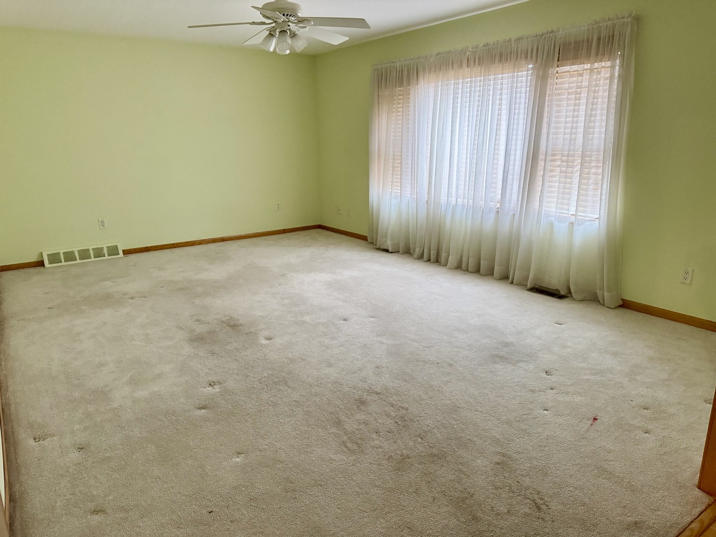 119 East 2nd Street Spring Valley, IL 61362 - Photo 7 of 10 an empty room with a window and a fan