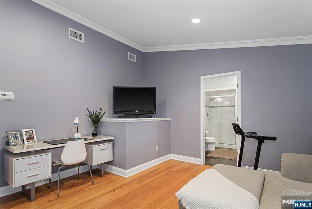 16 Barbara Way Wayne, NJ 07470 - Photo 18 of 35 a room with a chair and a flat screen tv