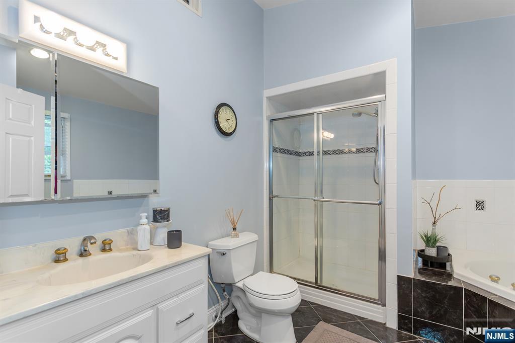 16 Barbara Way Wayne, NJ 07470 - Photo 20 of 35 a bathroom with a sink toilet and vanity