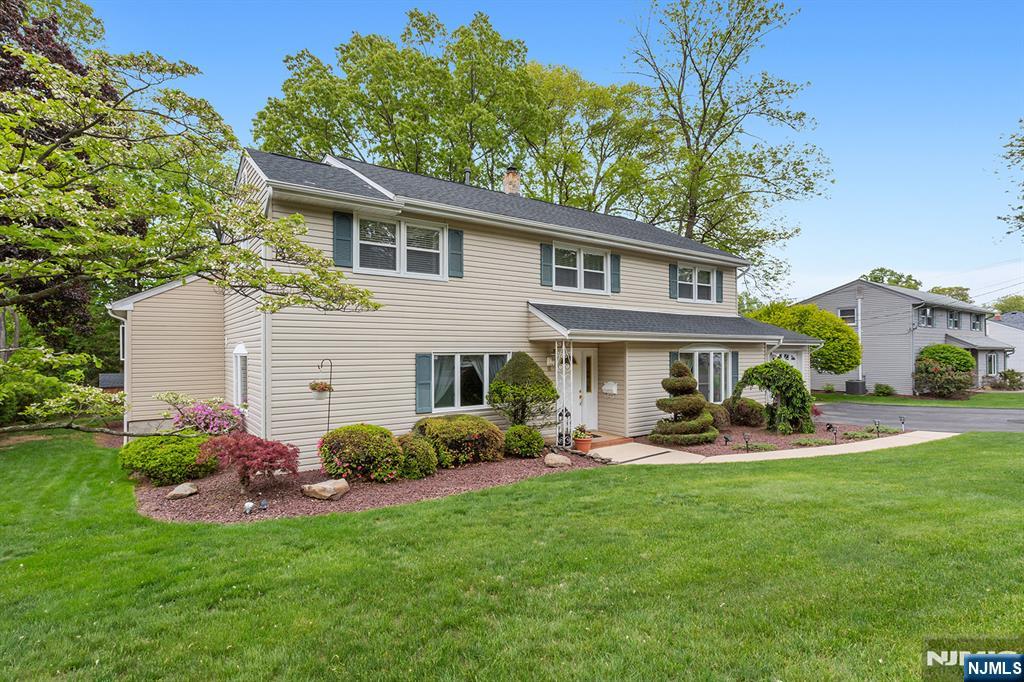 16 Barbara Way Wayne, NJ 07470 - Photo 2 of 35 a front view of a house with a garden and plants