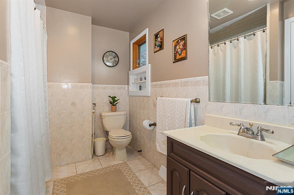 16 Barbara Way Wayne, NJ 07470 - Photo 22 of 35 a bathroom with a sink a toilet and shower curtain