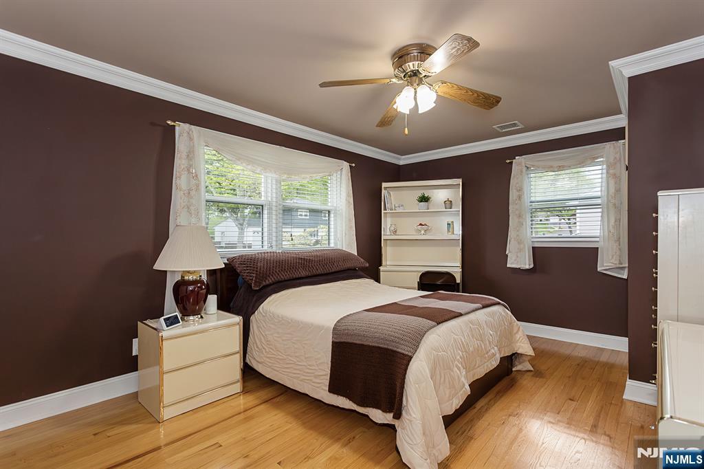 16 Barbara Way Wayne, NJ 07470 - Photo 23 of 35 a bedroom with a bed and a chandelier
