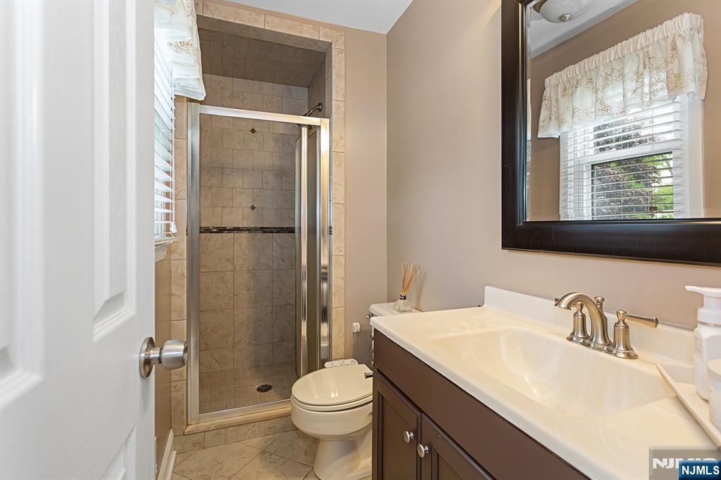 16 Barbara Way Wayne, NJ 07470 - Photo 24 of 35 a bathroom with a granite countertop sink toilet and shower