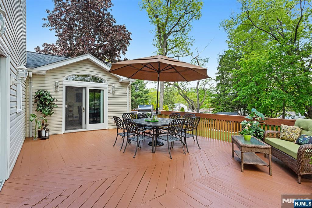 16 Barbara Way Wayne, NJ 07470 - Photo 30 of 35 a patio with wooden floor a yard a table and chairs