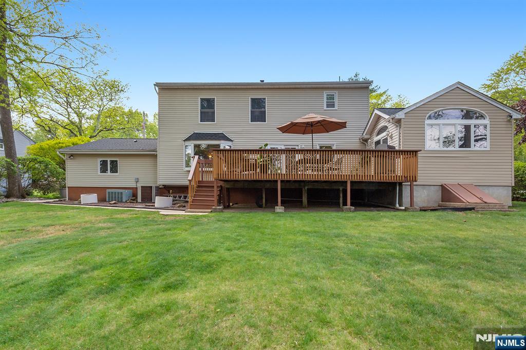 16 Barbara Way Wayne, NJ 07470 - Photo 32 of 35 a view of a house with a backyard and a patio