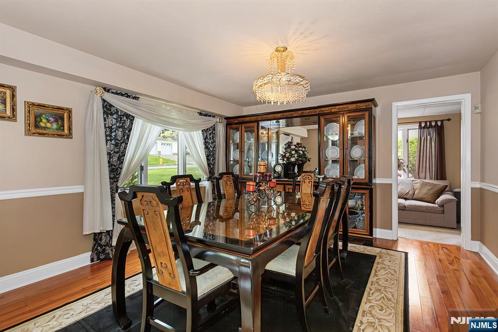 16 Barbara Way Wayne, NJ 07470 - Photo 6 of 35 a view of a dining room with furniture a chandelier and wooden floor