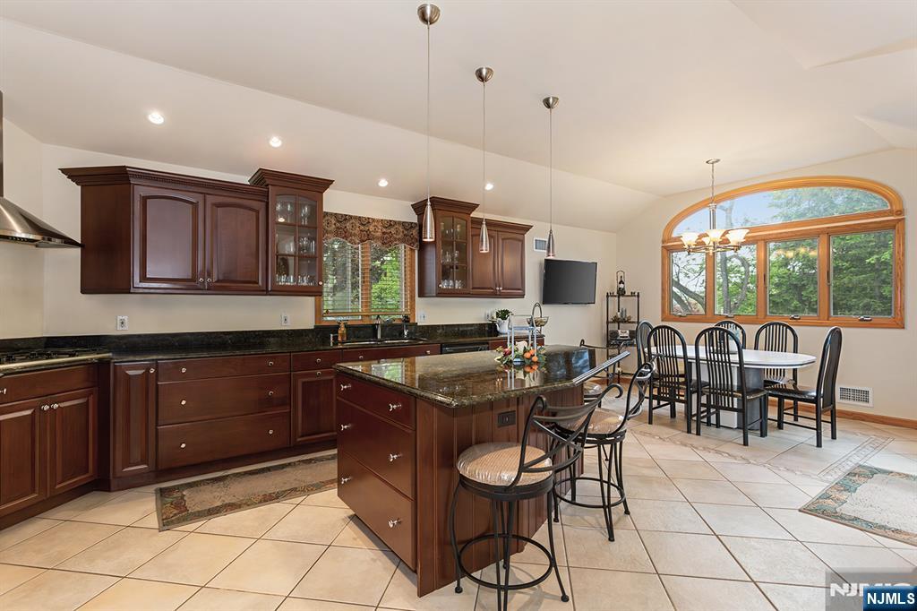 16 Barbara Way Wayne, NJ 07470 - Photo 7 of 35 a kitchen with stainless steel appliances granite countertop table chairs sink and cabinets