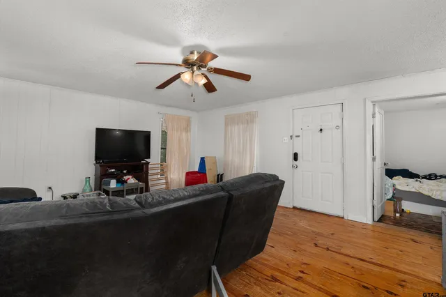 a living room with furniture and a flat screen tv