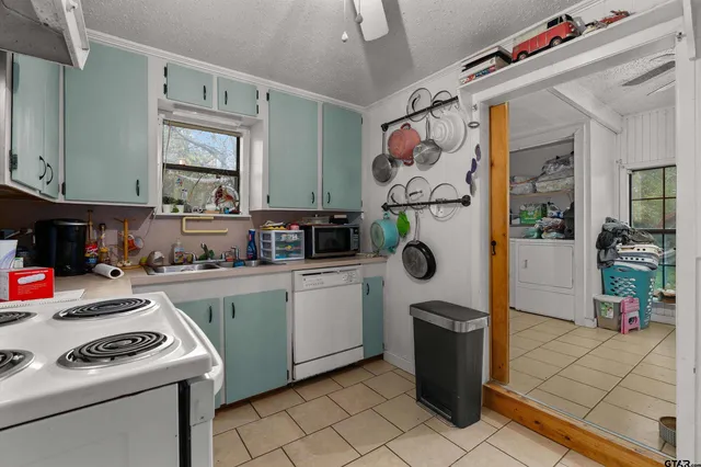 a kitchen with a refrigerator and a stove top oven