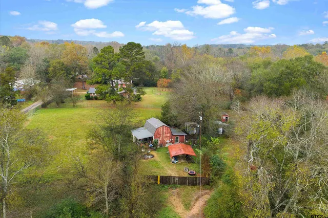 a view of residential houses with swimming pool and outdoor space