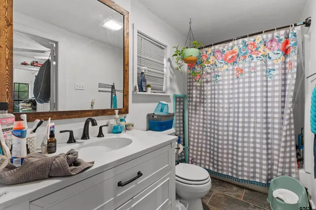 a bathroom with a sink toilet and shower