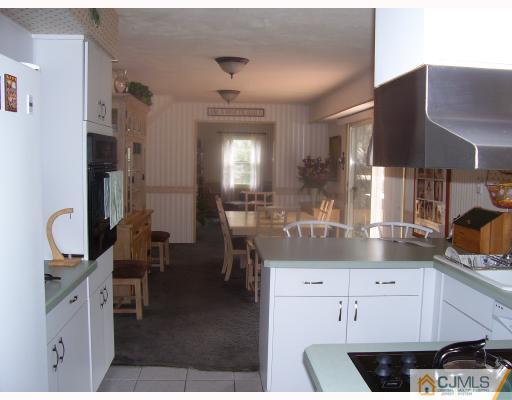 26 Johnson Road Somerset, NJ 08873 - Photo 3 of 9 a kitchen with cabinets and chairs