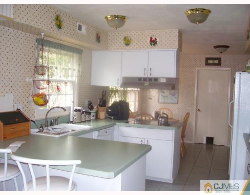 26 Johnson Road Somerset, NJ 08873 - Photo 4 of 9 a kitchen with stainless steel appliances granite countertop a sink a stove and a refrigerator