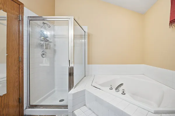 a bathroom with a tub and shower