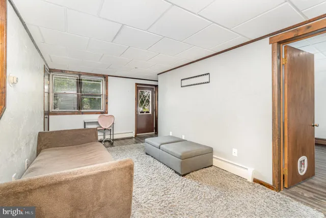 a living room with furniture and large windows