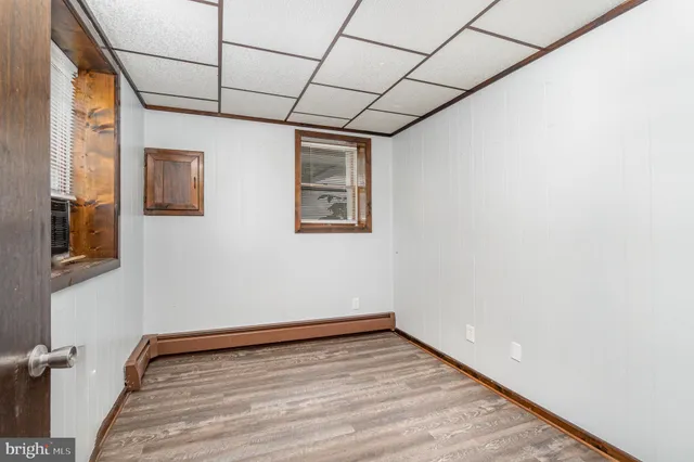 a view of a room with wooden floor and brick walls