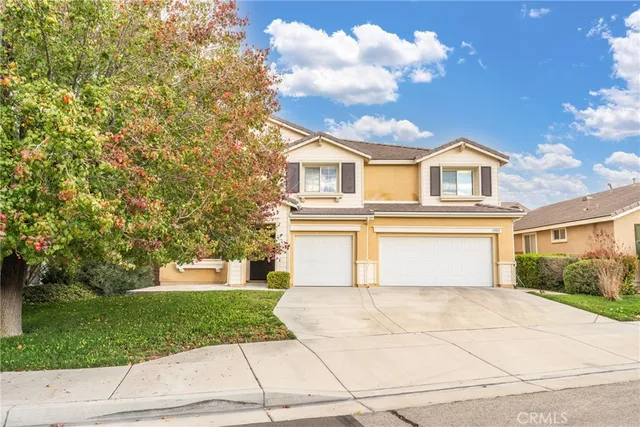 a front view of a house with a yard and a garage