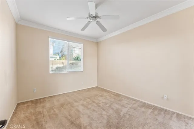 a view of an empty room and a ceiling fan