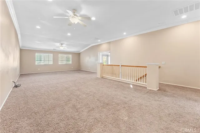 an empty room with a ceiling fan and a window