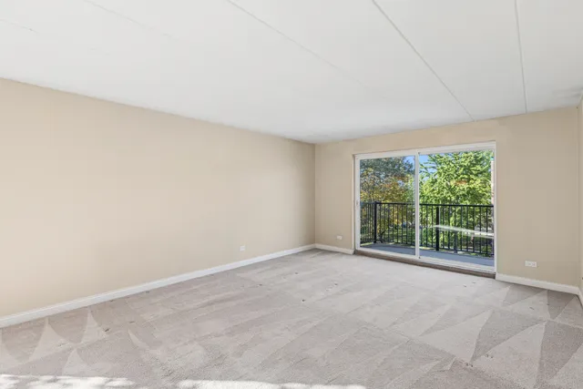 an empty room with large windows