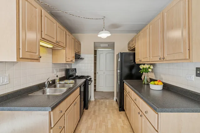 a kitchen with a sink stove and refrigerator