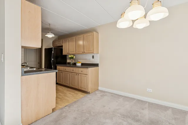 a kitchen with cabinets and stainless steel appliances