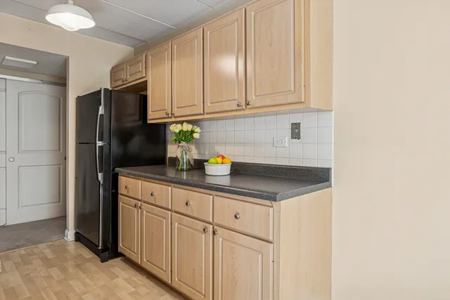 a kitchen with stainless steel appliances granite countertop a refrigerator sink and cabinets