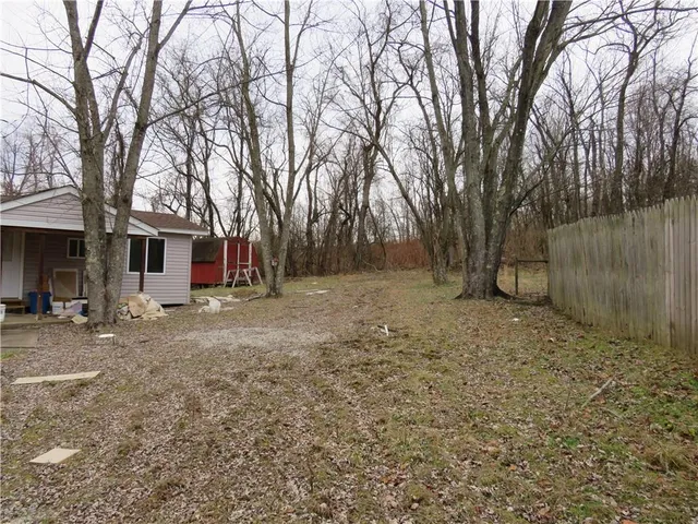 a view of a backyard with large trees