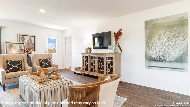 a living room with furniture a flat screen tv and a table