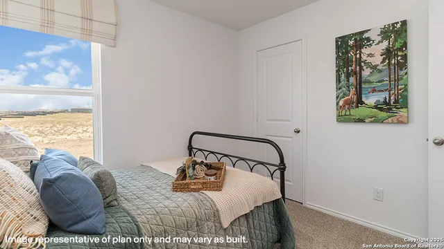 a bedroom with a bed and cabinets