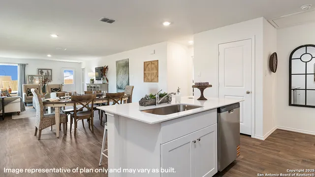 a kitchen with sink and white cabinets