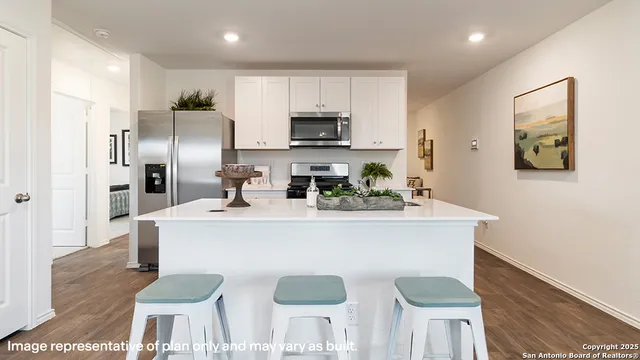 a kitchen with stainless steel appliances granite countertop a sink a stove and a refrigerator