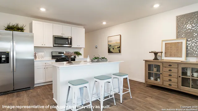 a kitchen with stainless steel appliances a refrigerator sink and microwave