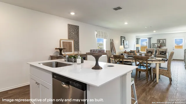 a kitchen with a sink a counter and chairs